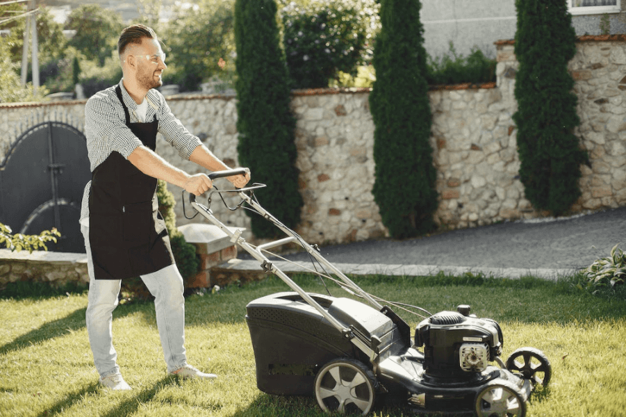 A person mowing a lawn.