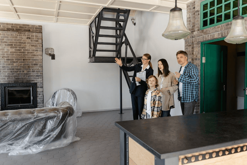 An agent showing the property to the new homeowners.