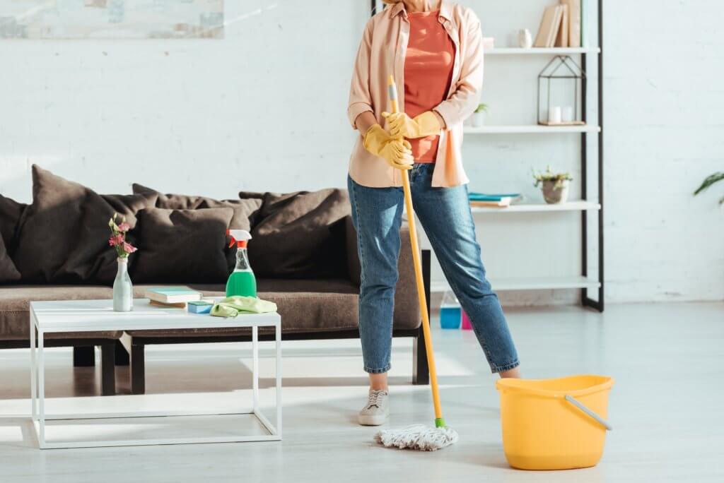 Person cleaning their house to keep pests away.
