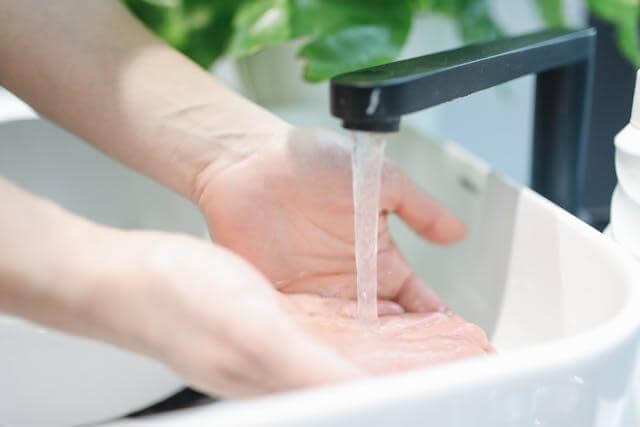 A person washing hands.